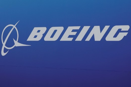 Boeing reported a quarterly loss but lifted production rates on key commercial plane models