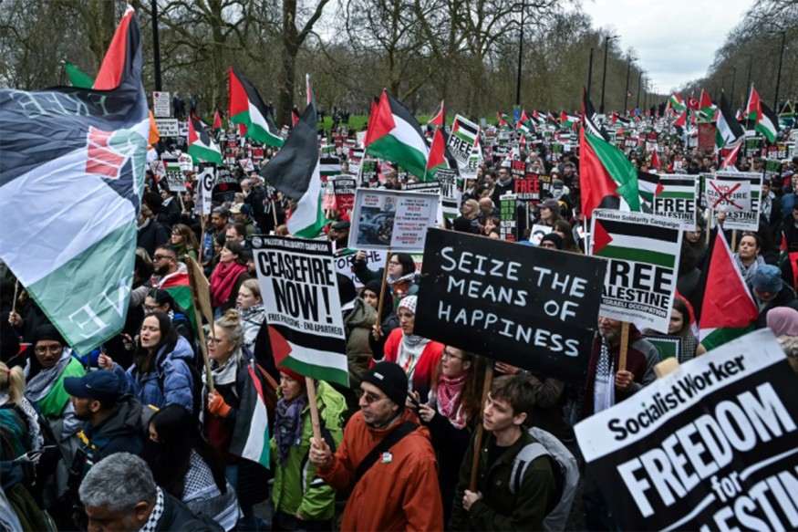 Pro-Palestinian activists and supporters wave flags and carry placards during a National March for Palestine in central London