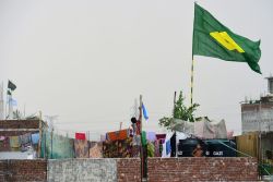 A child hoists the national flag of Argentina on the outskirts of Dhaka during the 2018 World Cup
