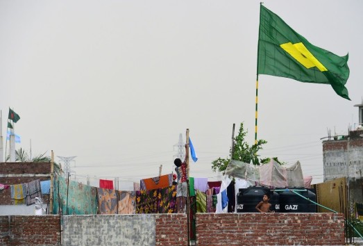 A child hoists the national flag of Argentina on the outskirts of Dhaka during the 2018 World Cup