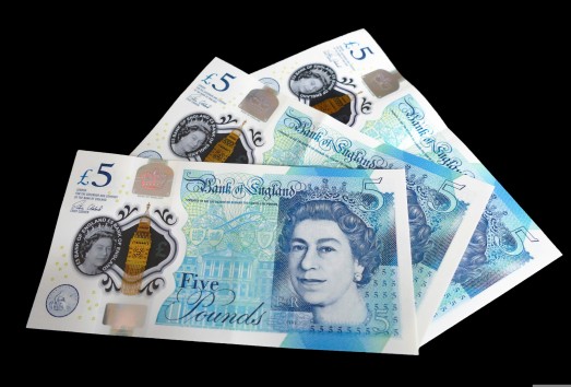 A pile of five-pound banknotes